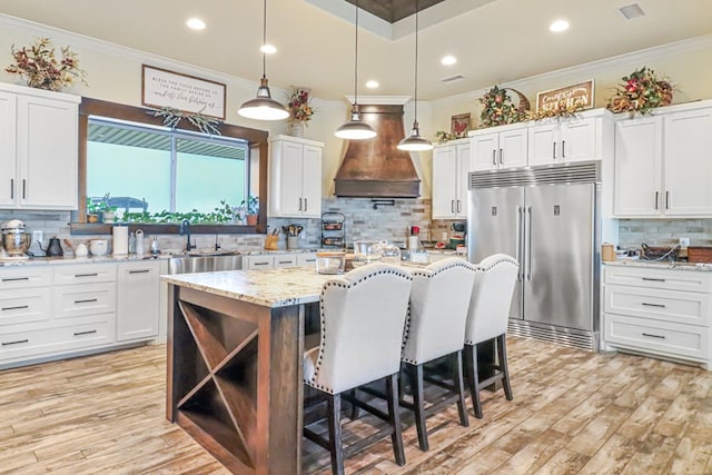 kitchen featuring white cabinetry and built in fridge