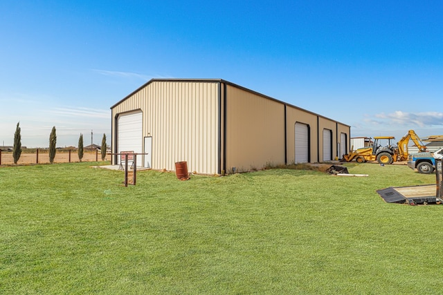 view of outbuilding featuring a lawn and a garage