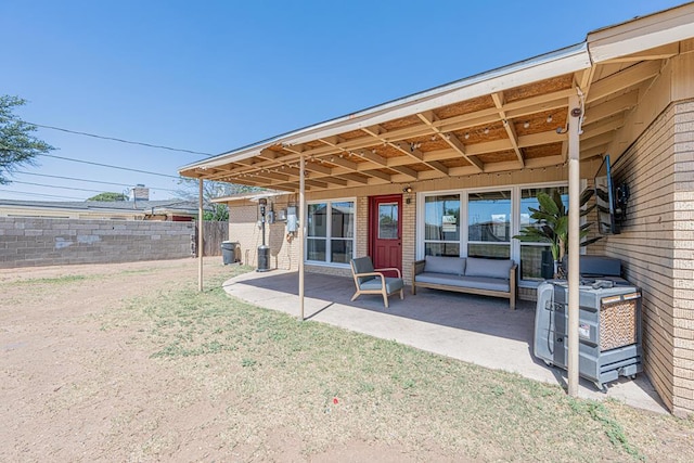 rear view of house featuring a patio area and brick siding
