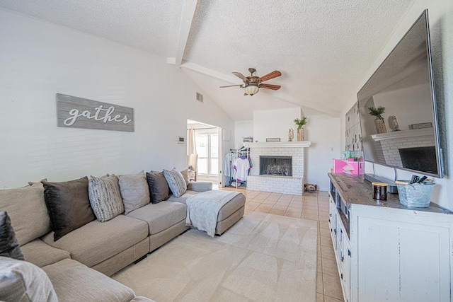 living room featuring a brick fireplace, light tile patterned flooring, a ceiling fan, and a textured ceiling