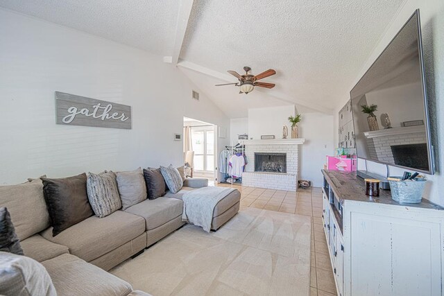 3502 Maple Ave, Odessa, TX 79762 - living room featuring a brick fireplace, light tile patterned flooring, a ceiling fan, and a textured ceiling