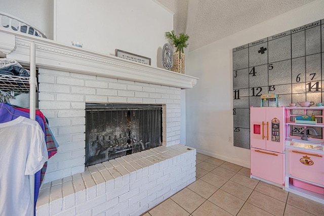 detailed view of a fireplace, a textured ceiling, and baseboards