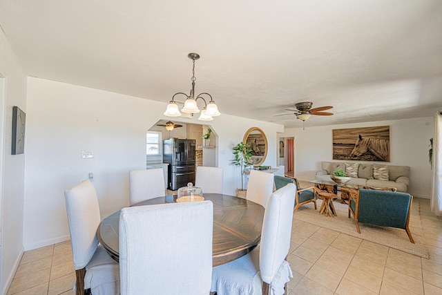 dining space with light tile patterned floors, ceiling fan, and baseboards