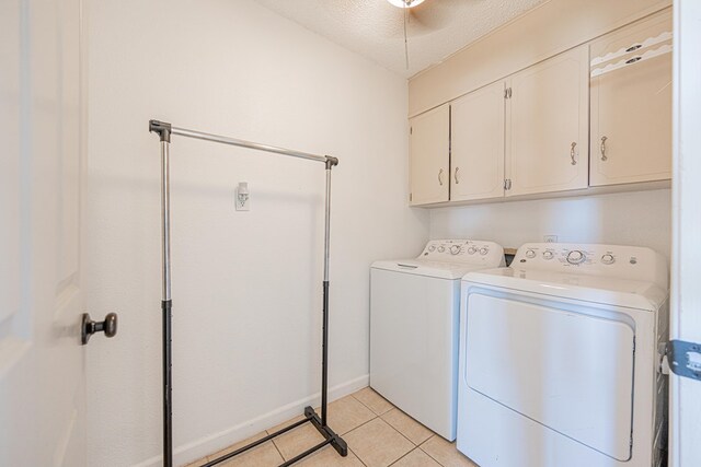 3502 Maple Ave, Odessa, TX 79762 - laundry room with cabinet space, washing machine and clothes dryer, a textured ceiling, light tile patterned floors, and baseboards