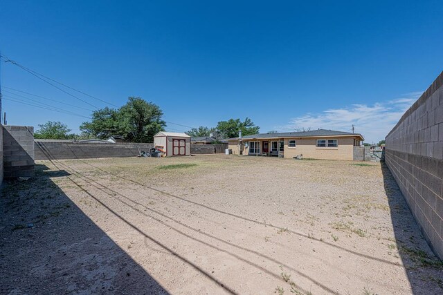 3502 Maple Ave, Odessa, TX 79762 - fenced backyard featuring a shed and an outdoor structure