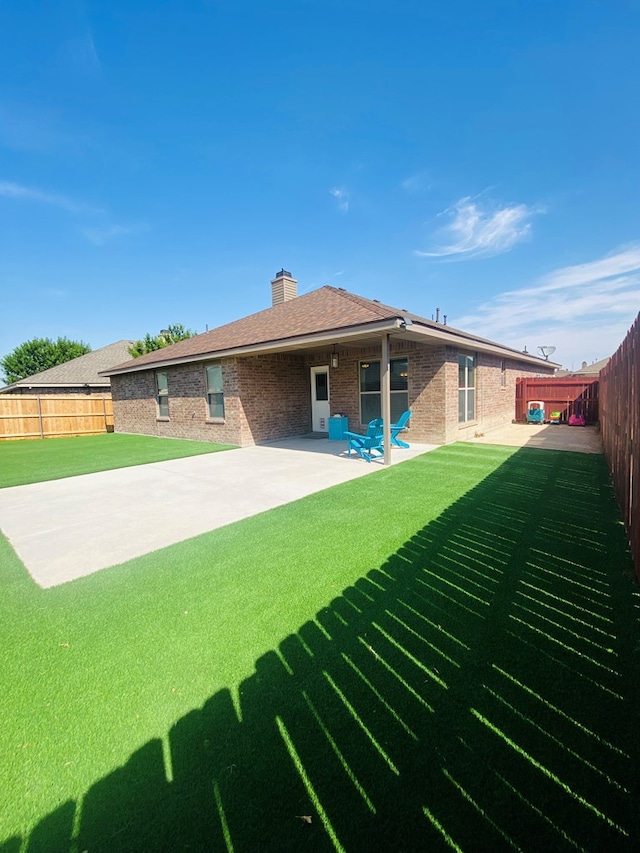 808 Brittlebush Ct, Odessa, TX 79765 - back of house featuring a patio, a chimney, and brick siding