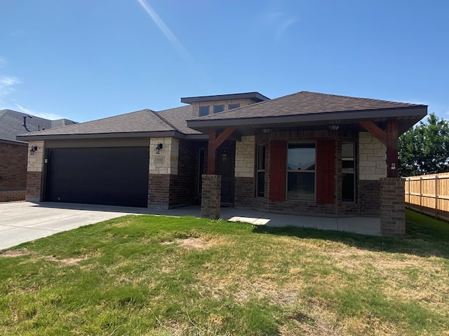 808 Brittlebush Ct, Odessa, TX 79765 - view of front of property featuring an attached garage, driveway, a shingled roof, and brick siding