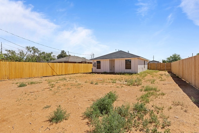 back of property featuring a fenced backyard