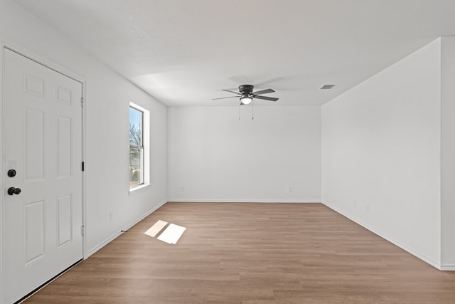 entryway featuring light wood-style floors, baseboards, a ceiling fan, and visible vents
