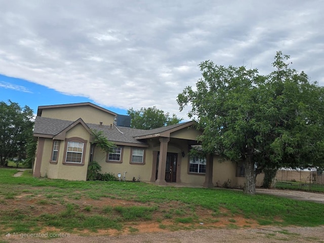 2301 Stoner Rd, Odessa, TX 79764 - ranch-style house featuring stucco siding, roof with shingles, and a front lawn