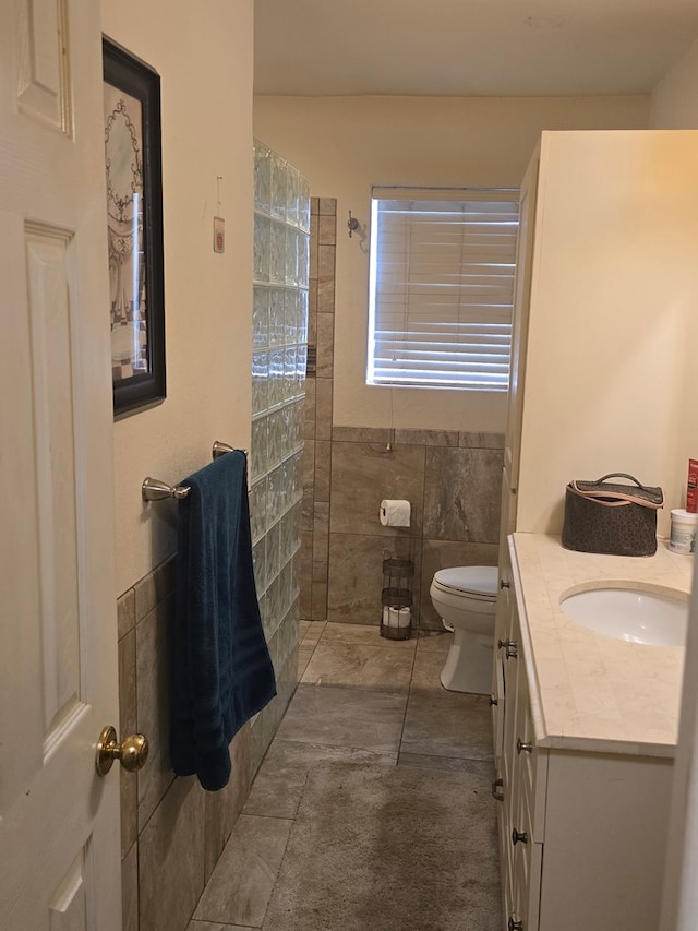 2301 Stoner Rd, Odessa, TX 79764 - full bath with vanity, walk in shower, and tile walls