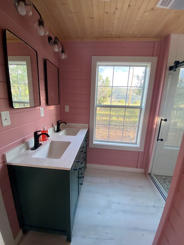 102 Low Meadow Pt, Fort Davis, TX 79734 - bathroom with wooden ceiling, double vanity, a shower stall, baseboards, and wood walls
