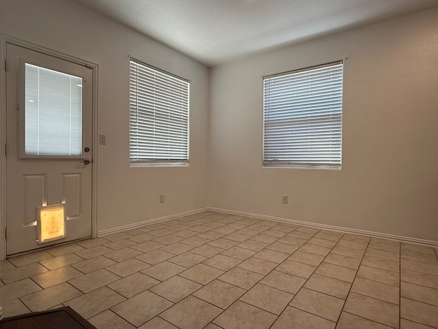 spare room with baseboards