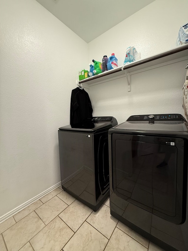 laundry area featuring washer and dryer, laundry area, and baseboards