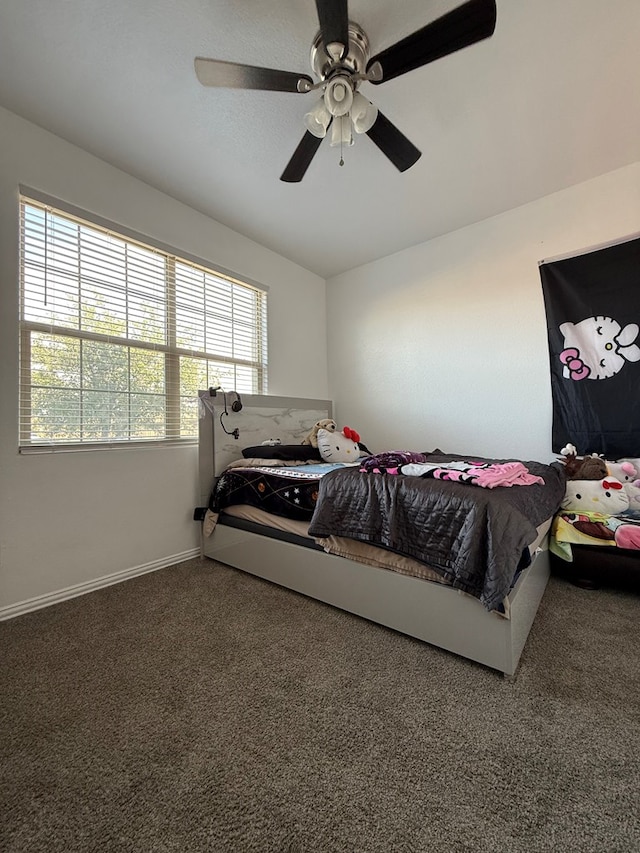carpeted bedroom with ceiling fan, multiple windows, and baseboards