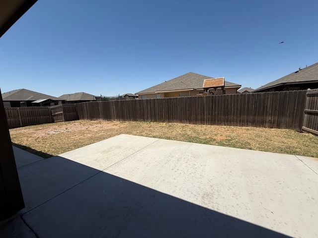 view of yard featuring a patio and a fenced backyard