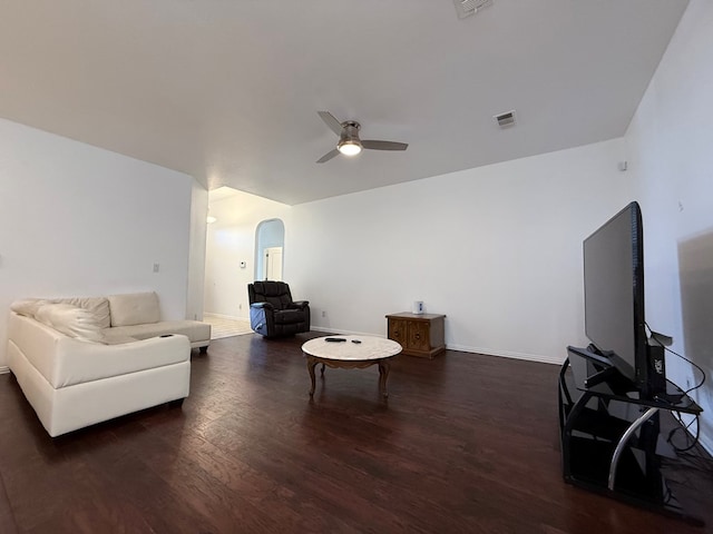 living room with ceiling fan, visible vents, arched walkways, wood finished floors, and baseboards