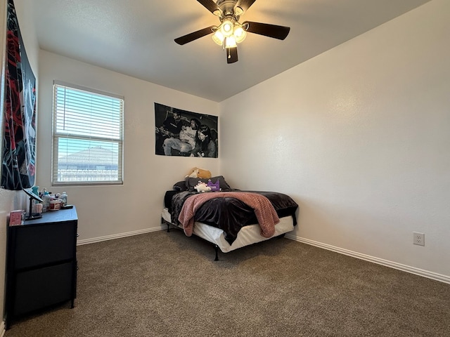 carpeted bedroom featuring baseboards and ceiling fan