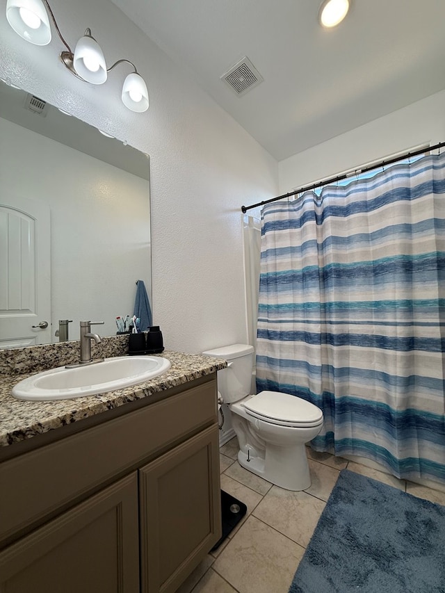 bathroom featuring vanity, tile patterned flooring, toilet, and visible vents