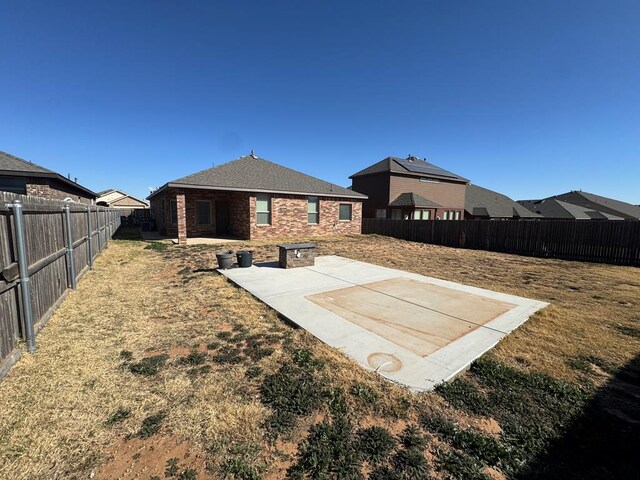 6981 King Ranch Rd, Odessa, TX 79765 - fenced backyard with a patio area