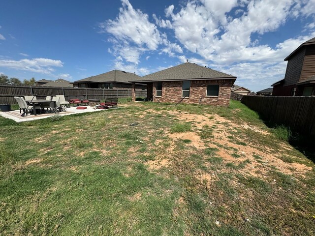 6981 King Ranch Rd, Odessa, TX 79765 - back of property featuring a patio area and a fenced backyard