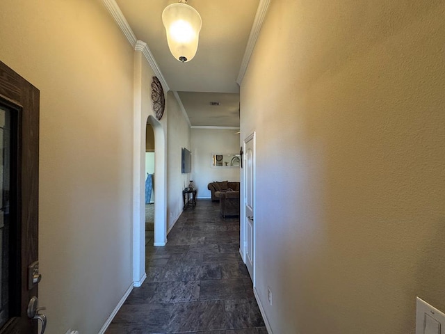 6981 King Ranch Rd, Odessa, TX 79765 - corridor featuring ornamental molding, arched walkways, and dark stone finish flooring