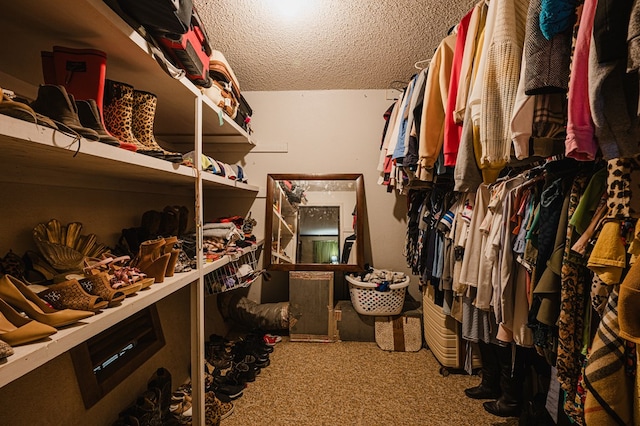 walk in closet featuring carpet floors