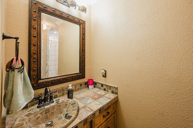 bathroom featuring vanity and tasteful backsplash