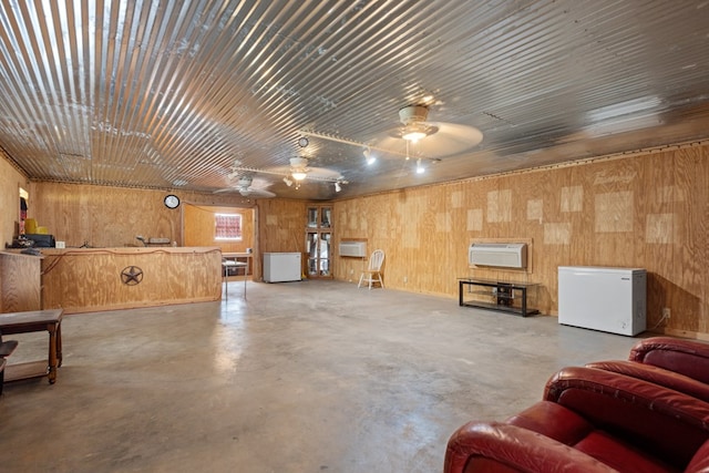 4975 SE 3000, Andrews, TX 79714 - miscellaneous room with a ceiling fan, finished concrete floors, wood walls, and a wall mounted AC