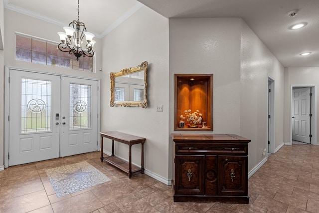 4975 SE 3000, Andrews, TX 79714 - entrance foyer with ornamental molding, a towering ceiling, a chandelier, and french doors