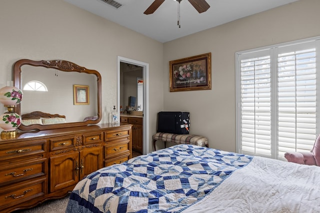4975 SE 3000, Andrews, TX 79714 - bedroom with multiple windows, ensuite bathroom, and a ceiling fan