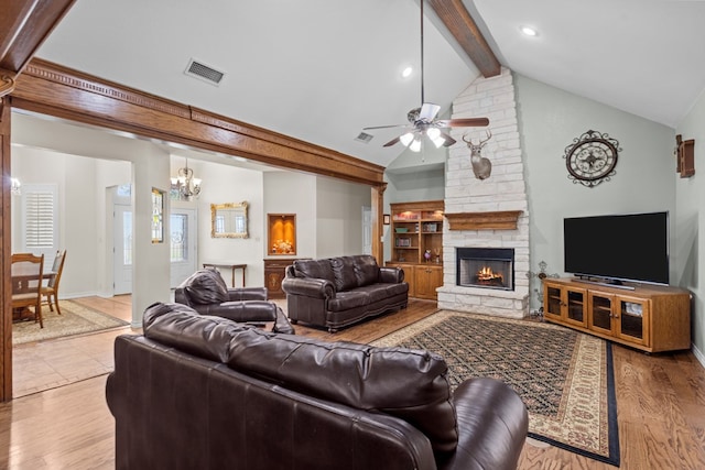 4975 SE 3000, Andrews, TX 79714 - living room with beam ceiling, a fireplace, ceiling fan, a chandelier, and wood finished floors