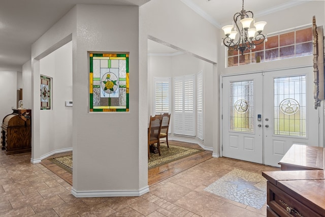 4975 SE 3000, Andrews, TX 79714 - foyer with a chandelier, crown molding, french doors, and stone finish flooring