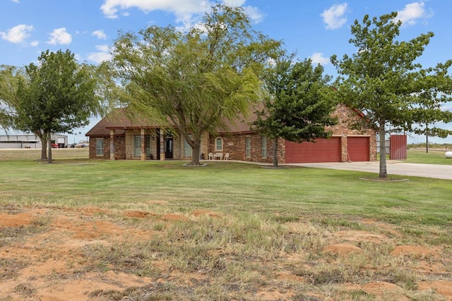4975 SE 3000, Andrews, TX 79714 - view of green lawn featuring a garage and driveway