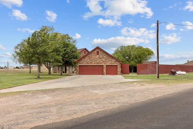 4975 SE 3000, Andrews, TX 79714 - view of front facade featuring concrete driveway, stone siding, and a garage