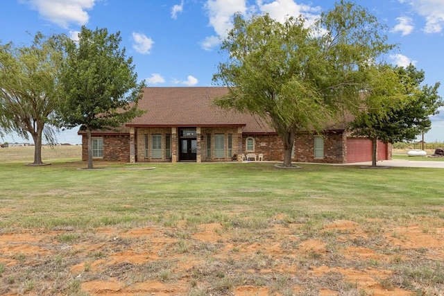 4975 SE 3000, Andrews, TX 79714 - view of front of home with a front lawn, an attached garage, stone siding, and driveway