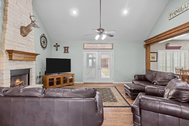 4975 SE 3000, Andrews, TX 79714 - living room featuring ceiling fan, a stone fireplace, high vaulted ceiling, plenty of natural light, and wood finished floors