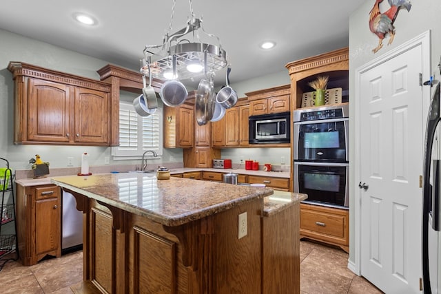 4975 SE 3000, Andrews, TX 79714 - kitchen featuring stainless steel appliances, brown cabinets, a center island, recessed lighting, and light tile patterned floors