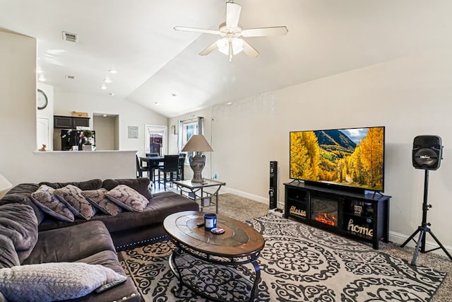 living room featuring vaulted ceiling, carpet floors, and ceiling fan