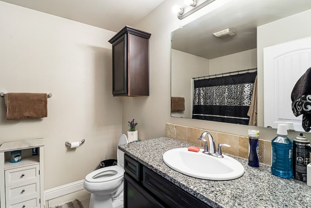 bathroom featuring vanity and toilet