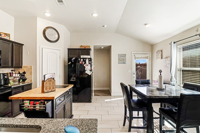 tiled dining room with vaulted ceiling