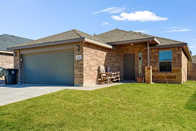 view of front of house featuring a garage and a front lawn