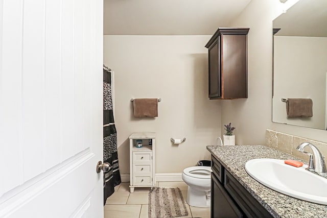 bathroom with vanity, toilet, and tile patterned flooring