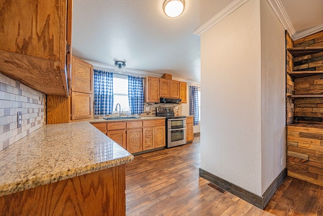 kitchen with double oven range, decorative backsplash, dark wood-type flooring, crown molding, and sink