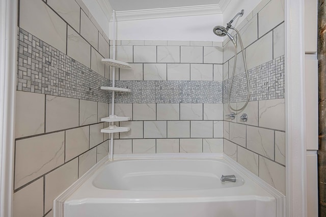 bathroom featuring ornamental molding and tiled shower / bath