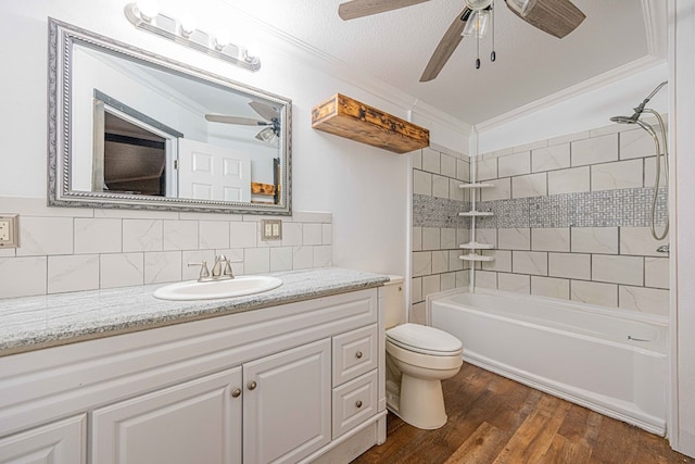 full bathroom with toilet, hardwood / wood-style floors, decorative backsplash, tiled shower / bath, and vanity