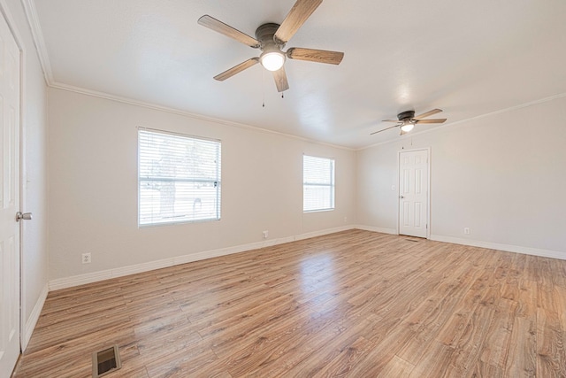 unfurnished room with a wealth of natural light, light hardwood / wood-style flooring, and crown molding