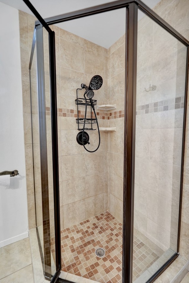 bathroom with tile patterned floors and walk in shower