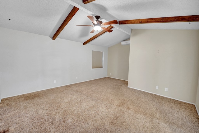 carpeted spare room featuring ceiling fan, a textured ceiling, and vaulted ceiling with beams