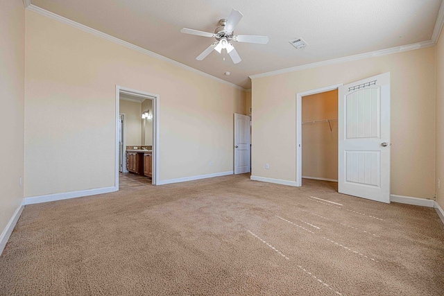 unfurnished bedroom with ceiling fan, ornamental molding, light carpet, and ensuite bath